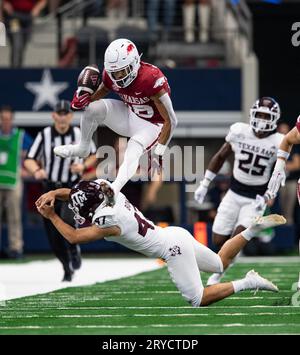 Arlington, Texas, USA. 30th Sep, 2023. Arkansas player #16 WR ISAIAH SATEGNA jumping over Texas A&M PLAYER #47 LB ATOA ESKEETS (Credit Image: © Hoss McBain/ZUMA Press Wire) EDITORIAL USAGE ONLY! Not for Commercial USAGE! Stock Photo