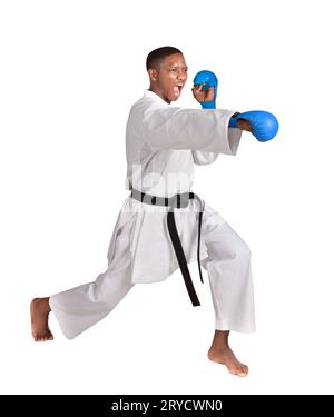 african american karate man in a fighting stance, exercising his kata, in white kimono uniform with belt and gloves Stock Photo