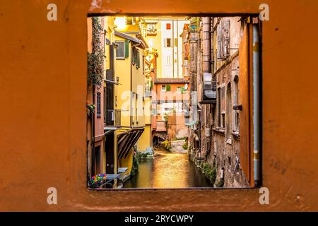 Water canal hidden behind a window in Italy Stock Photo
