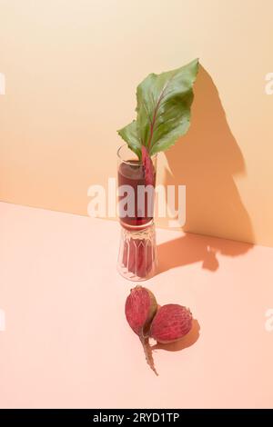 Red beet, leaf and beet juice in a glass. Minimal healthy composition. Close-up Stock Photo