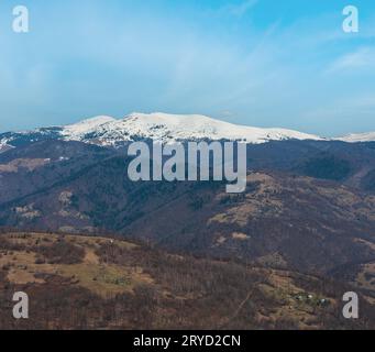 Early spring Carpathian mountains plateau landscape with snow-covered ridge tops in far, Ukraine. Stock Photo