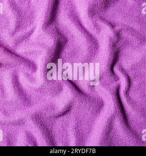 Abstract background made of crumpled soft fabric in purple color, close-up top view Stock Photo