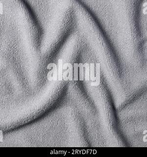 Abstract background of crumpled soft fabric in neutral gray color, close-up top view. Stock Photo