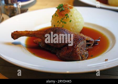 Portion of duck confit leg, dumpling and gravy Stock Photo