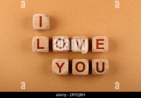 Wooden cubes with I LOVE YOU words over red Stock Photo