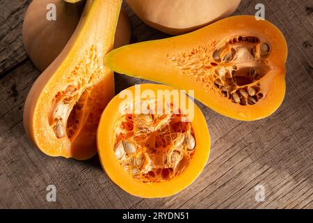 Close up of Fresh butternut squash on rustic wooden table Stock Photo
