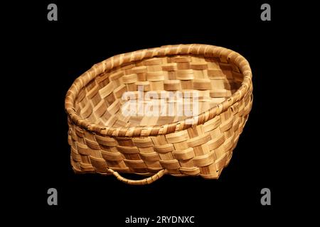 Traditional wicker basket isolated on black background Stock Photo