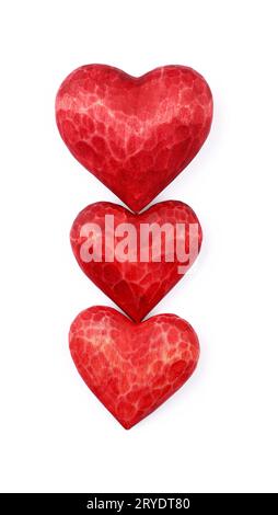 Three red wooden carved hearts isolated on white Stock Photo