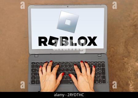 In this photo illustration, the Roblox logo is displayed on a laptop screen. Stock Photo