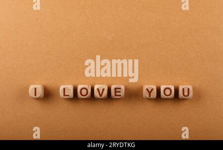 Wooden cubes with I LOVE YOU words over red Stock Photo