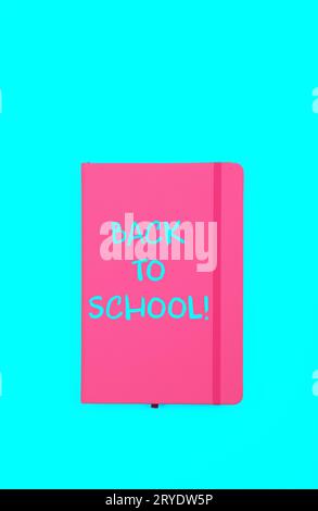 Back to school sign on pink notebook Stock Photo