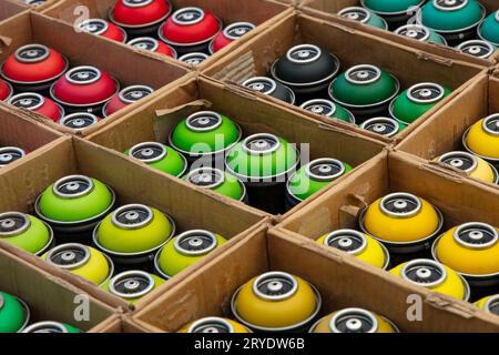 Graffiti spray paint cans in cardboard boxes Stock Photo