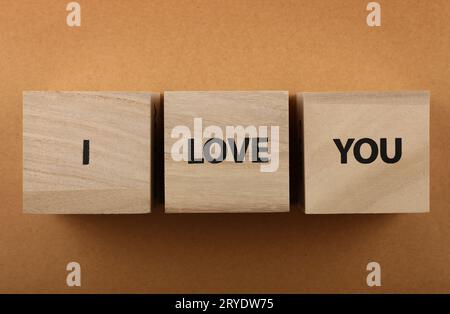 Wooden cubes with I LOVE YOU words over red Stock Photo