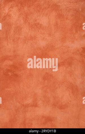 Grunge orange painted plaster wall background Stock Photo