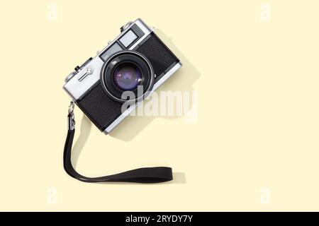 Flat lay film camera isolated on yellow background Stock Photo