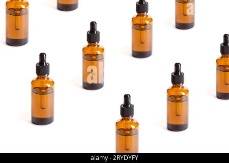 Pattern of Amber Bottles with dropper on white background Stock Photo