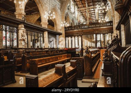 Wakefield, England - May 13, 2023: Cathedral Church of All Saints in Wakefield, Interior view towards the nave, monuments, stained glass windows, benc Stock Photo