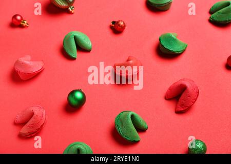 Fortune cookies and Christmas baubles scattered on red background Stock Photo