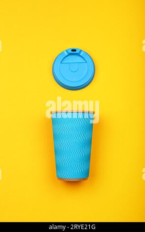 Blue paper coffee cup over yellow Stock Photo