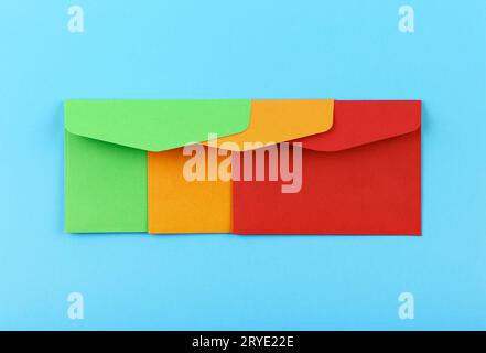 Three colorful envelopes over blue Stock Photo