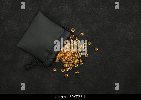 Heap of golden rhinestone crystals in bag Stock Photo