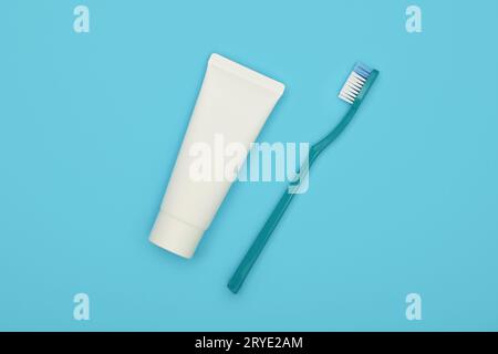 White toothpaste and plastic toothbrush on blue Stock Photo