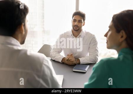 Team of young doctors talking on meeting, discussing work cases Stock Photo