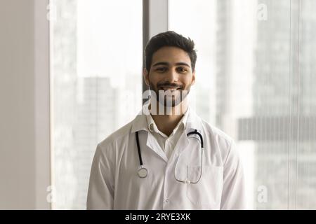 Happy handsome young Arab doctor man posing for shooting Stock Photo