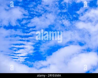 Unusual cloud formation, puffy clouds and striped clouds, in blue sky over Kona, Big Island, Hawaii. Stock Photo