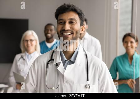 Happy doctor man standing in front of diverse team Stock Photo