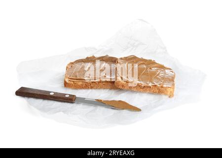 Baking paper of toasts with peanut butter on white background Stock Photo