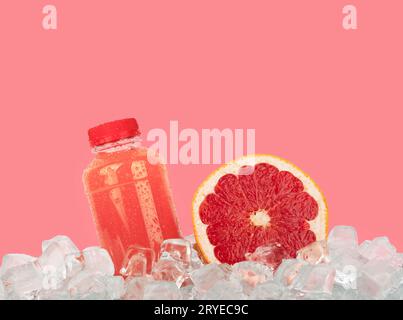 Fresh pink grapefruit juice and cut slice on ice Stock Photo