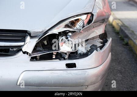 Car crash or accident. Front fender and light damage and scratches on bumper Stock Photo