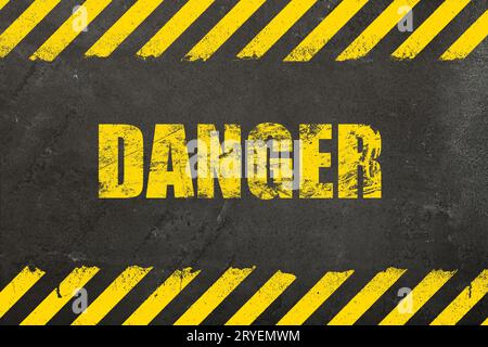 Concrete background with grunge danger sign Stock Photo