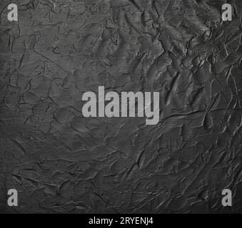 Black uneven grunge surface abstract background Stock Photo