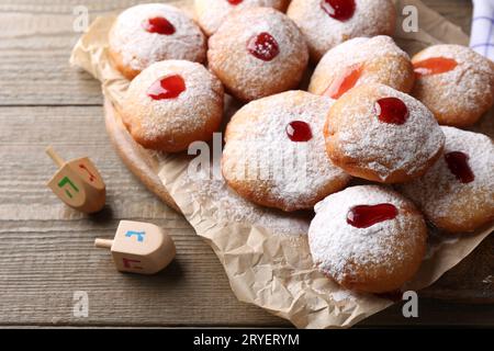 Hanukkah donuts and dreidels on wooden table Stock Photo