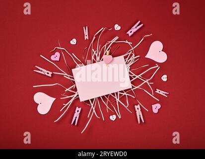 Pink Valentine paper card note on maroon red Stock Photo