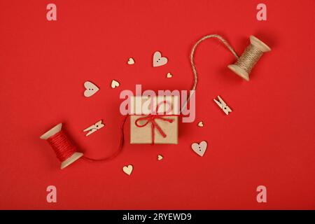 Packing brown paper Valentine gift box on red Stock Photo