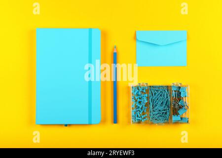 Blue stationery flat lay over yellow Stock Photo