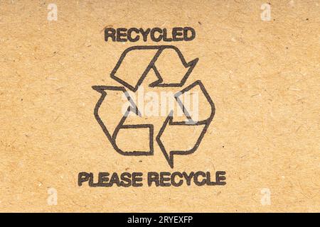 Recycle symbol on brown recycled cardboard background Stock Photo