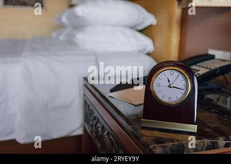 vintage clock in hotel bedroom Stock Photo