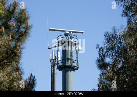 Coastal surveillance radar system on forest. Marine surveillance station. Copy space Stock Photo