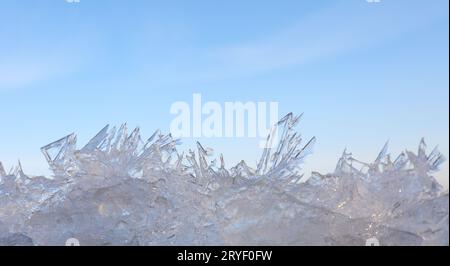Close up ice crystals pattern over blue sky Stock Photo
