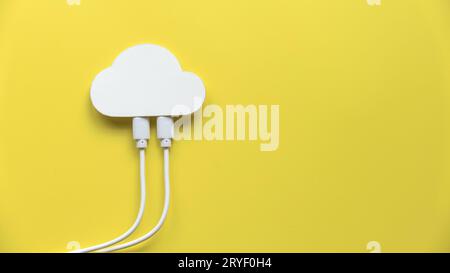 Cloud computing data storage concept.Network computing technologies. Digital server. Icon of cloud with white cables on yellow background with copy sp Stock Photo