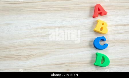 Education, learning and developement concept. Wooden alphabet of ABCD on a wooden background. Copy space. Stock Photo