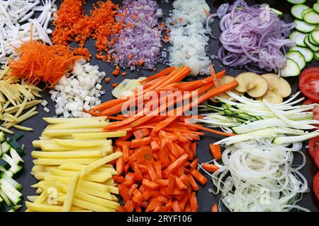 Assorted cut sliced vegetables on cooking board Stock Photo