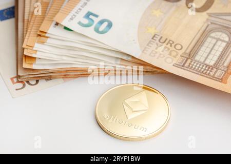 Ethereum coin and Euro banknotes. Blockchain money versus fiat money concept Stock Photo