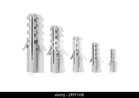 Group of Plastic dowels isolated on a white background. Wall plugs in different sizes Stock Photo