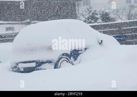 Car covered in snow on winter day Stock Photo