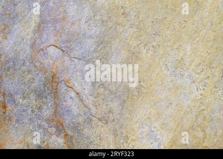 Natural stone background texture with yellow, beige and purple tones Stock Photo